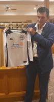 President Brett Dennis shows off the new Harriers Strip